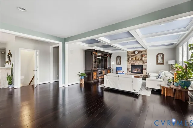 a living room with fireplace furniture and a potted plant