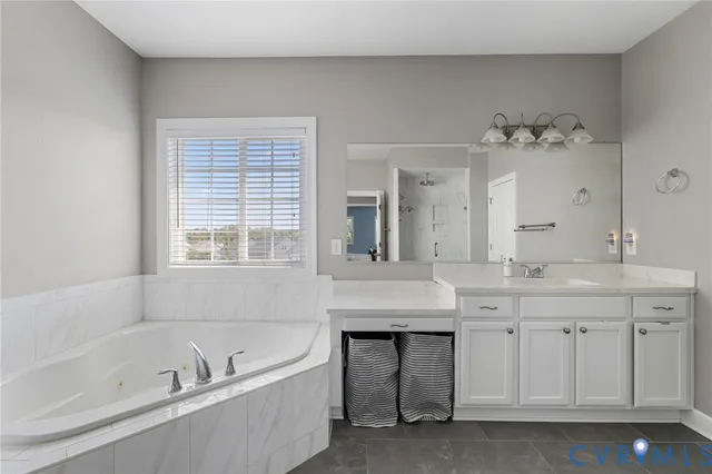 a bathroom with a granite countertop sink a toilet a vanity and shower