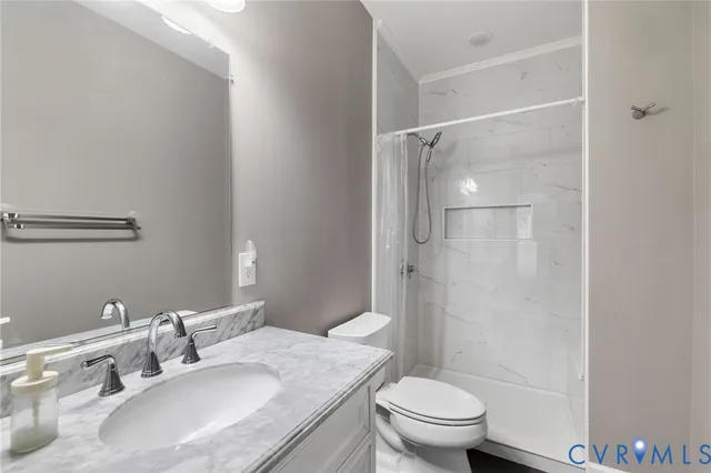 a living room with a baby crib and a refrigerator