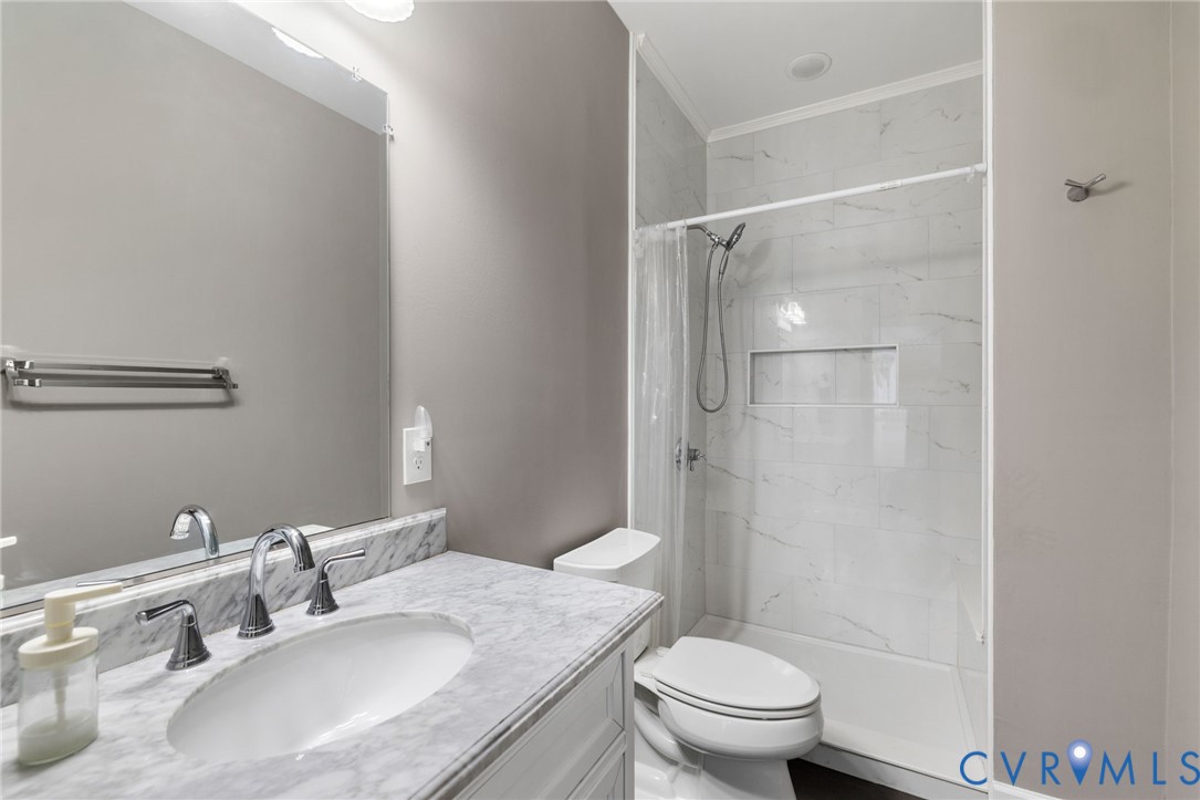12008 Stable Ridge Terrace Glen Allen, VA 23059 - Photo 23 of 38 a bathroom with a granite countertop sink toilet and shower
