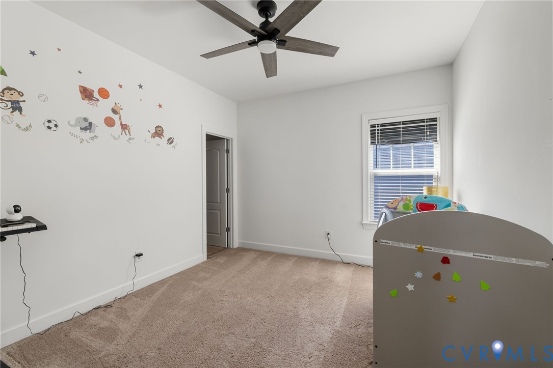 12008 Stable Ridge Terrace Glen Allen, VA 23059 - Photo 24 of 38 a living room with a baby crib and a refrigerator