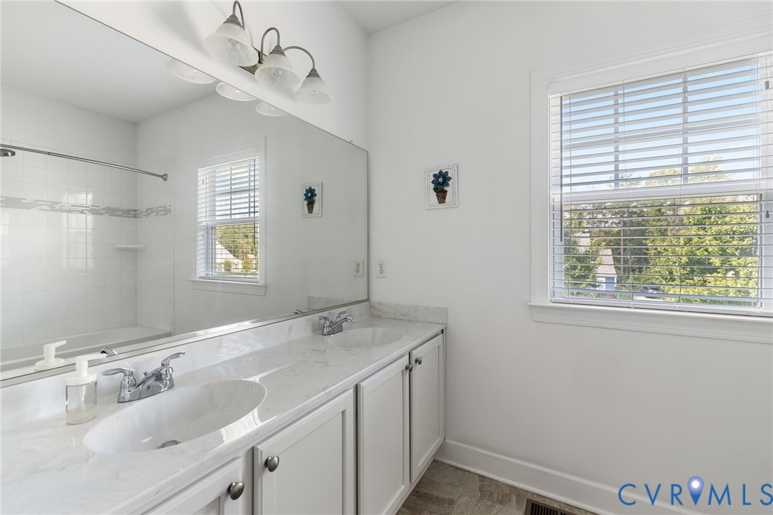12008 Stable Ridge Terrace Glen Allen, VA 23059 - Photo 27 of 38 a bathroom with a sink a vanity and a mirror