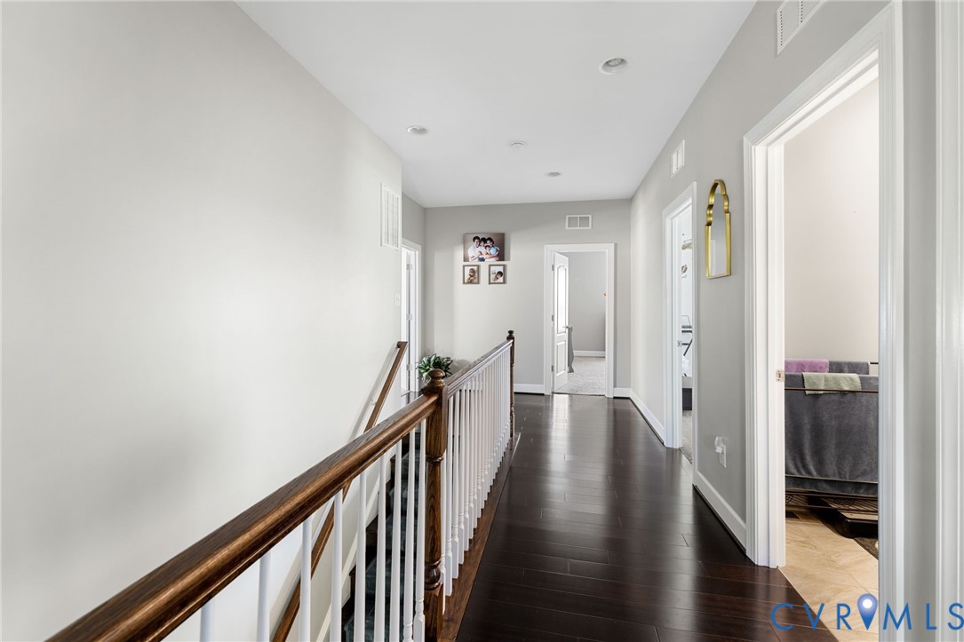 12008 Stable Ridge Terrace Glen Allen, VA 23059 - Photo 28 of 38 a view of a hallway with wooden floor and staircase