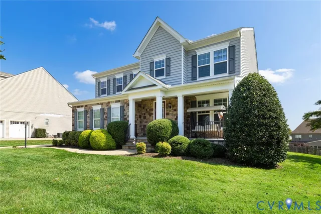 a front view of a house with a yard and porch