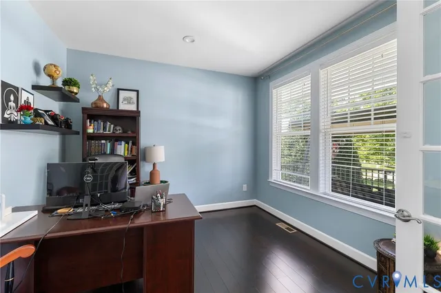 a view of a workspace with furniture and a window
