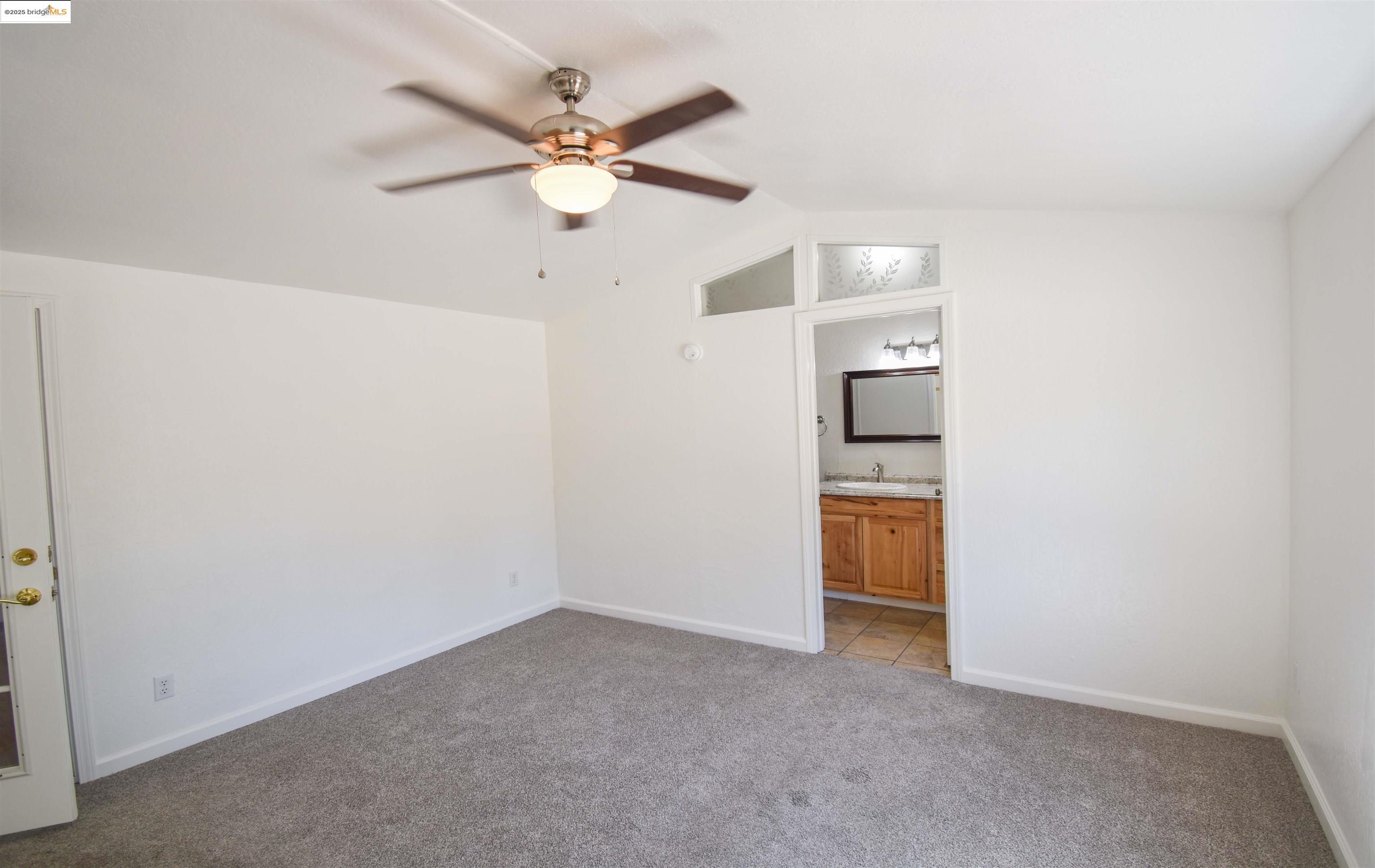 17390 Campbells Flat Road Sonora, CA 95370 - Photo 12 of 37 an empty room with a window and a kitchen
