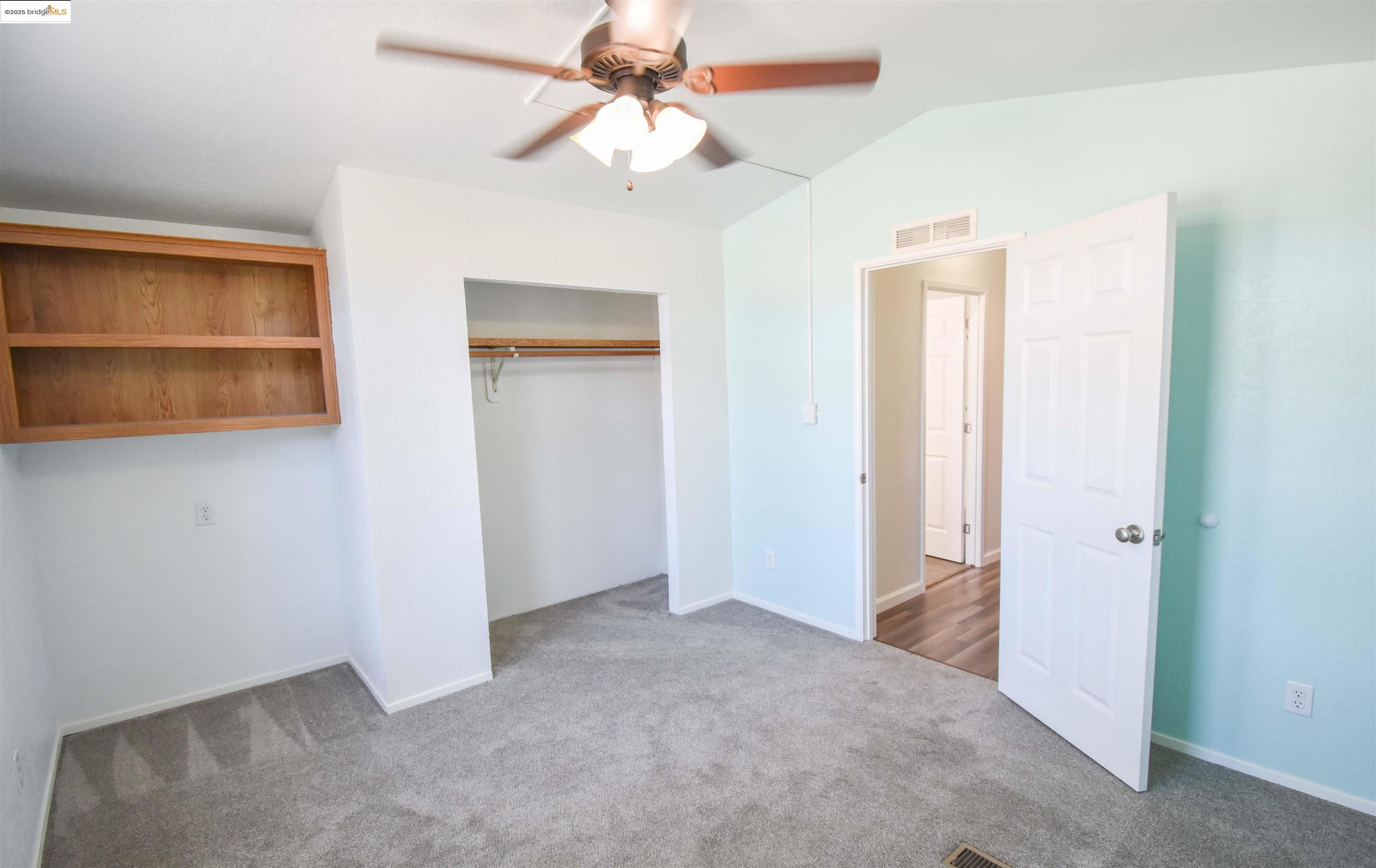 17390 Campbells Flat Road Sonora, CA 95370 - Photo 18 of 37 an empty room with closet and a ceiling fan