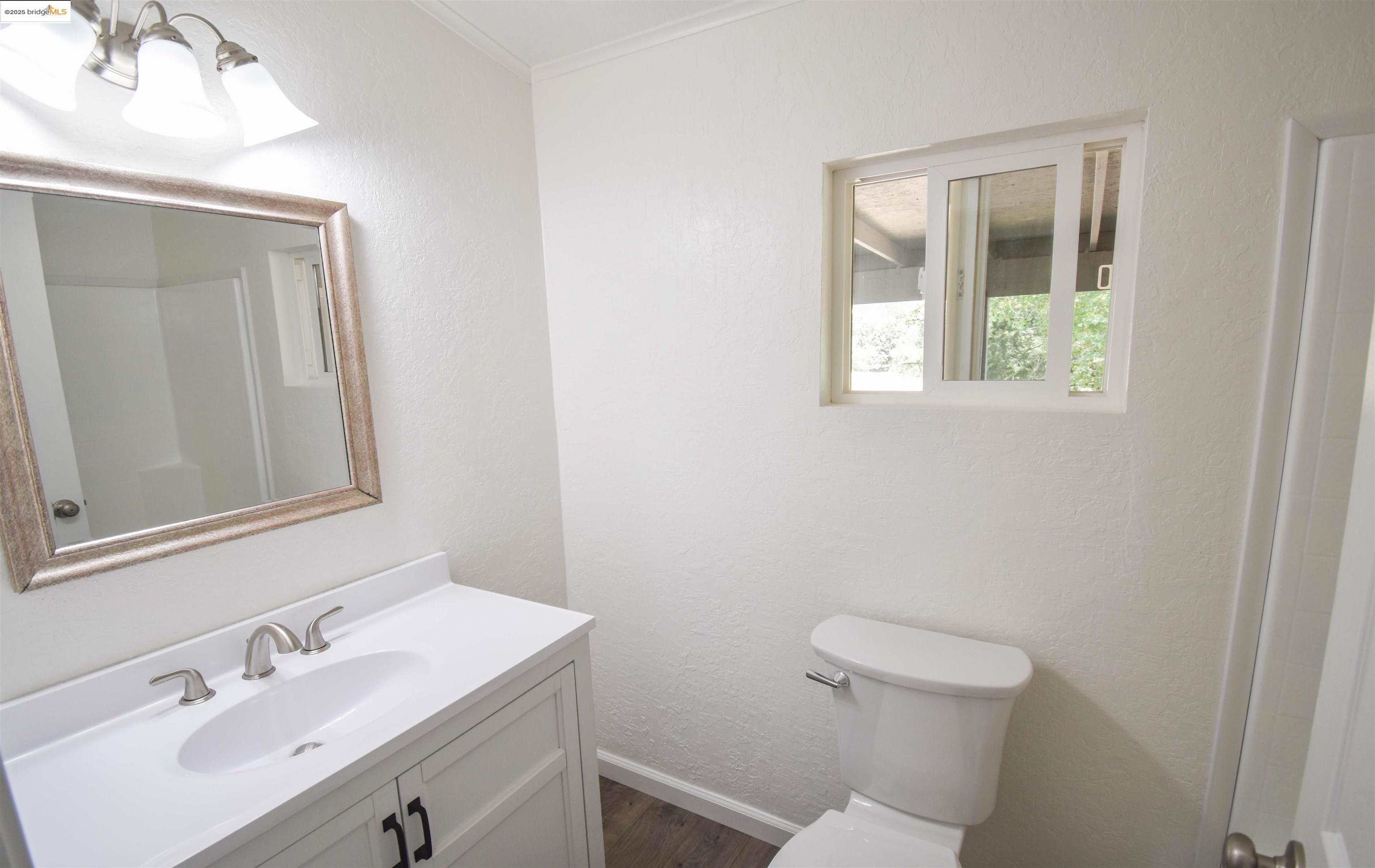 17390 Campbells Flat Road Sonora, CA 95370 - Photo 19 of 37 a bathroom with a sink a toilet and a mirror
