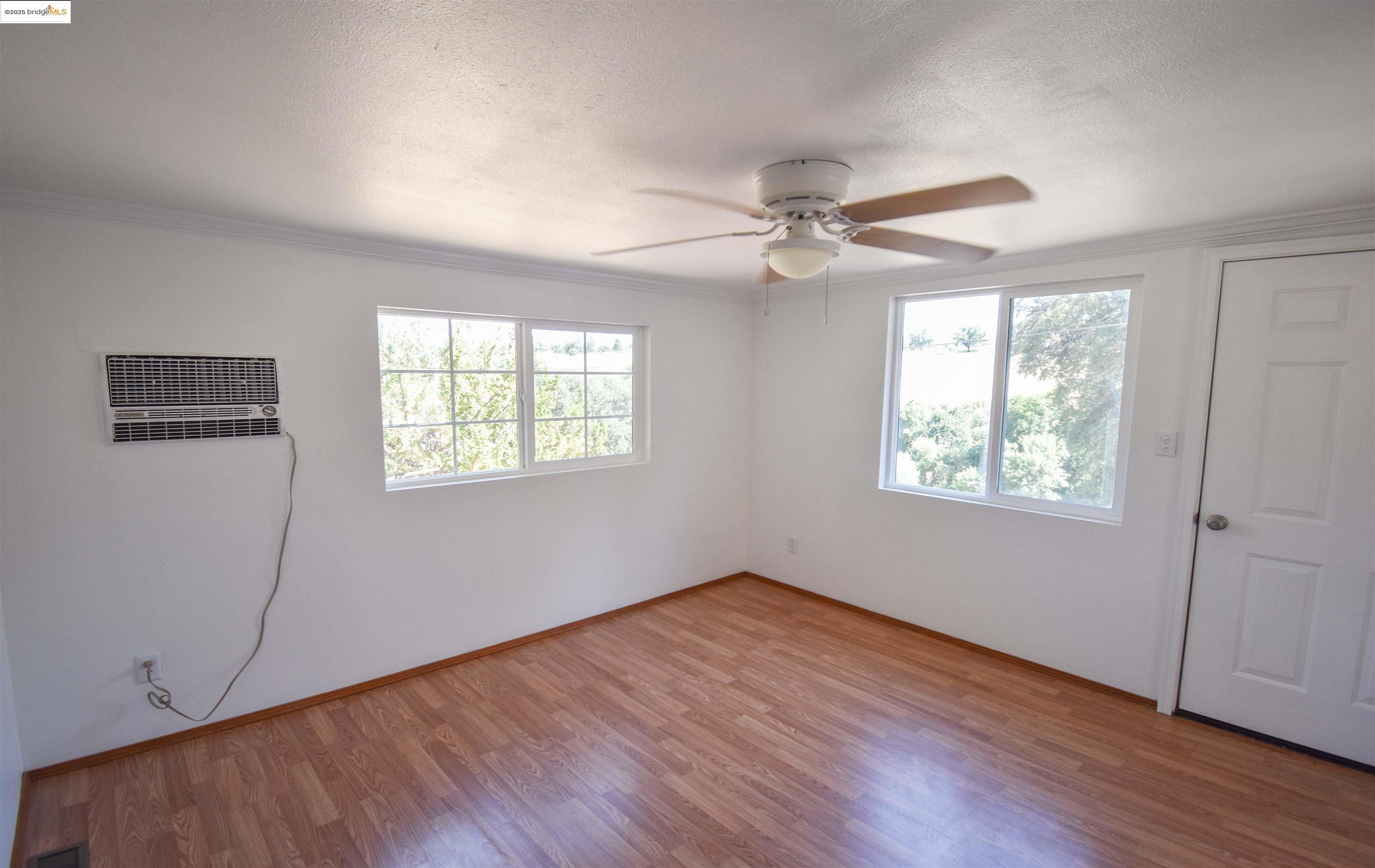 17390 Campbells Flat Road Sonora, CA 95370 - Photo 24 of 37 a view of an empty room with wooden floor and a window