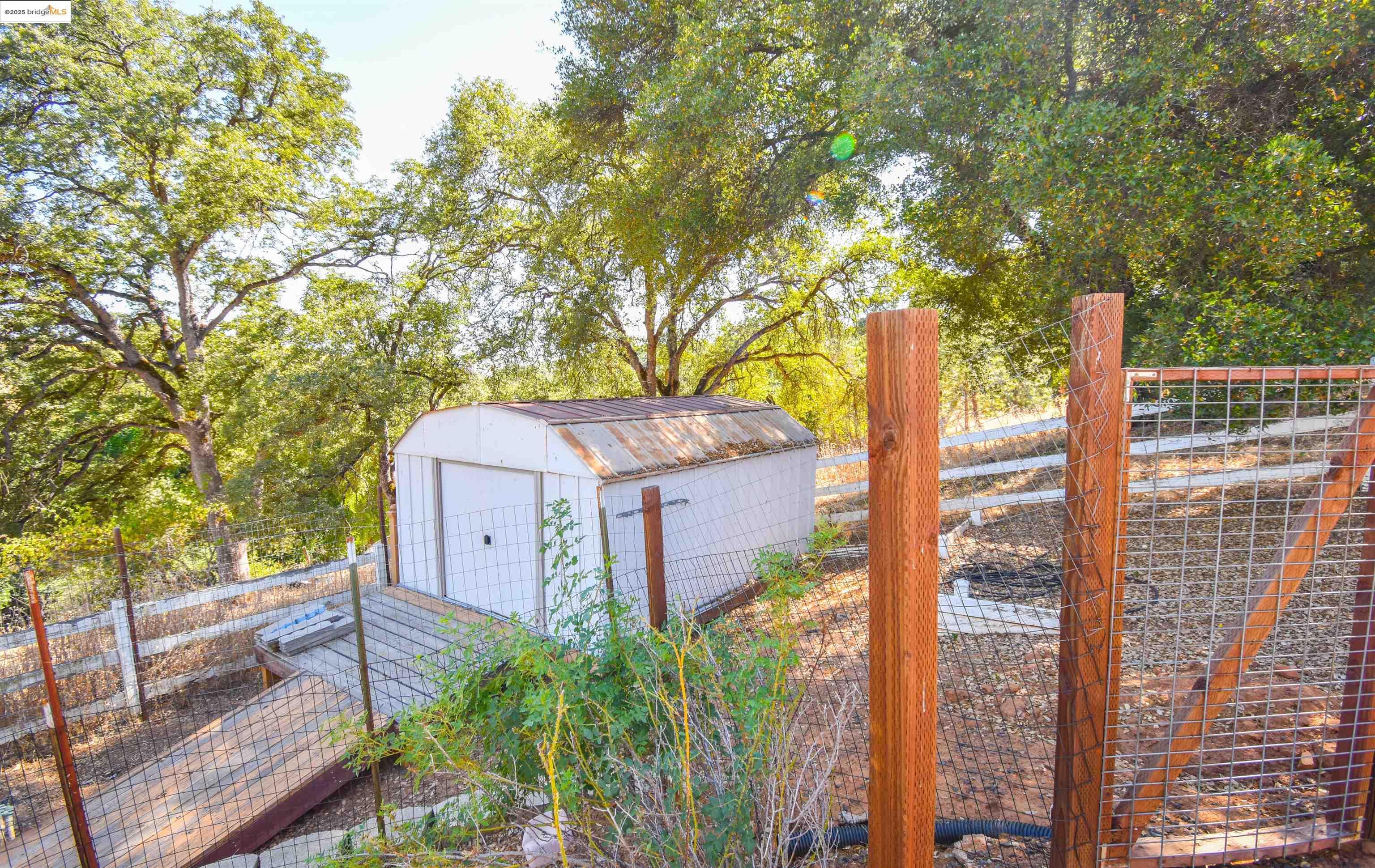 17390 Campbells Flat Road Sonora, CA 95370 - Photo 31 of 37 a front view of a house with a garden