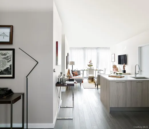 a living room with furniture kitchen view and a window