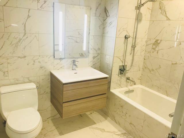 131-01 40 Road, Unit 17S Queens, NY 11354 - Photo 6 of 21 a bathroom with a sink a toilet and shower