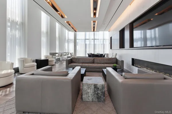 a living room with furniture and large windows