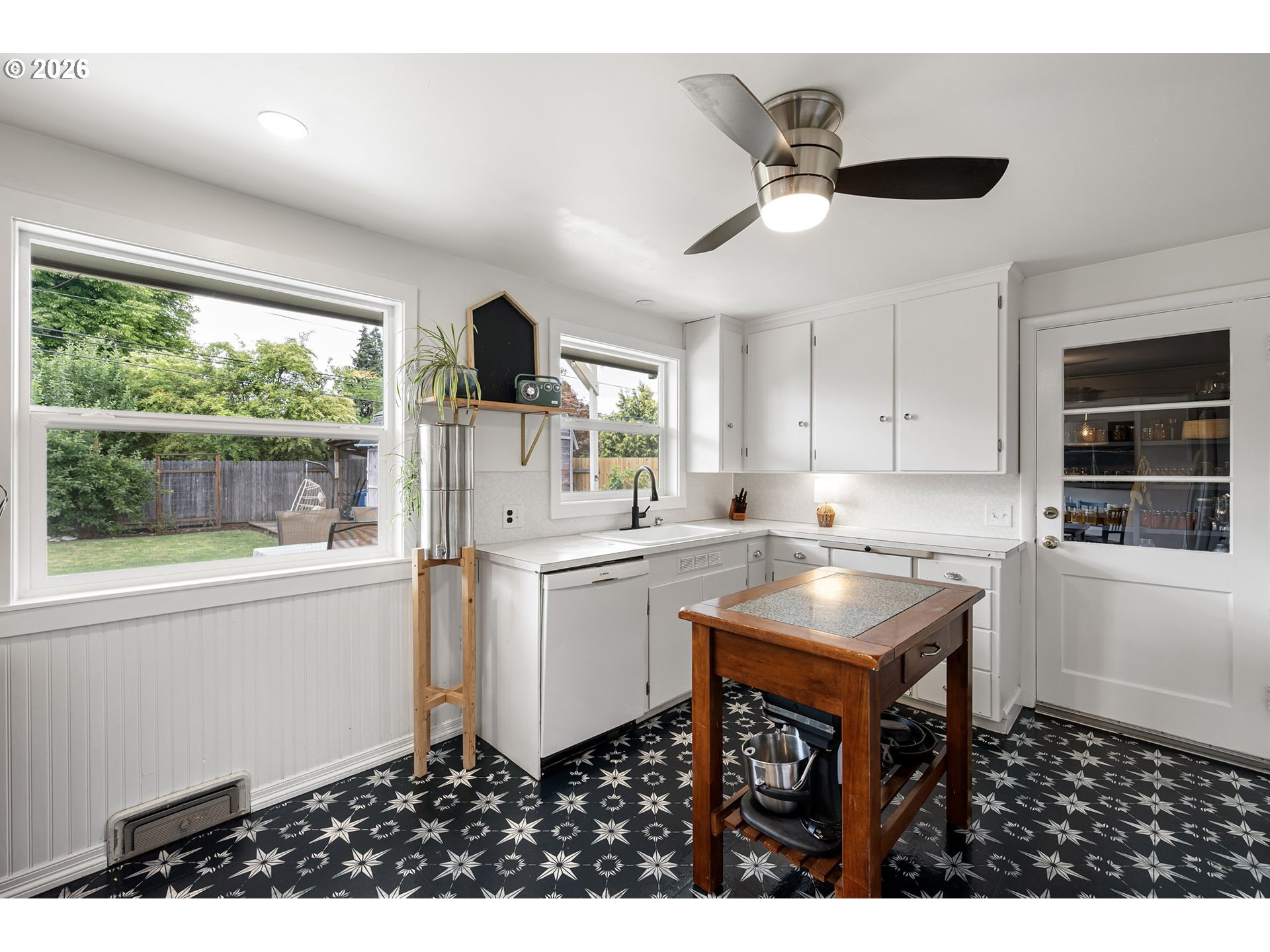 765 Louis Street Eugene, OR 97402 - Photo 15 of 45 a kitchen with kitchen island white cabinets and wooden floor