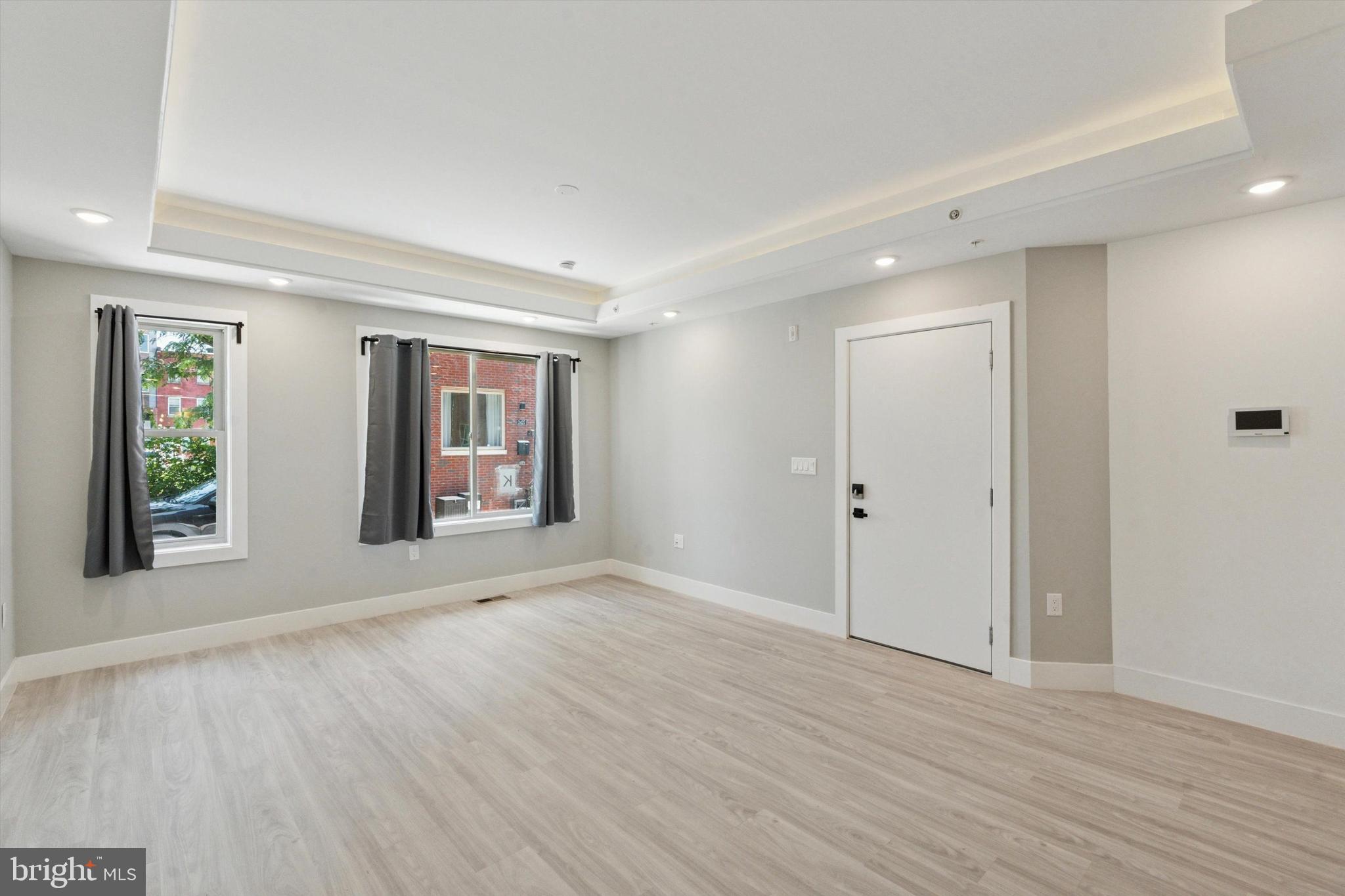 2401 North 2nd Street, Unit E1 Philadelphia, PA 19133 - Photo 11 of 12 a view of an empty room with wooden floor and window