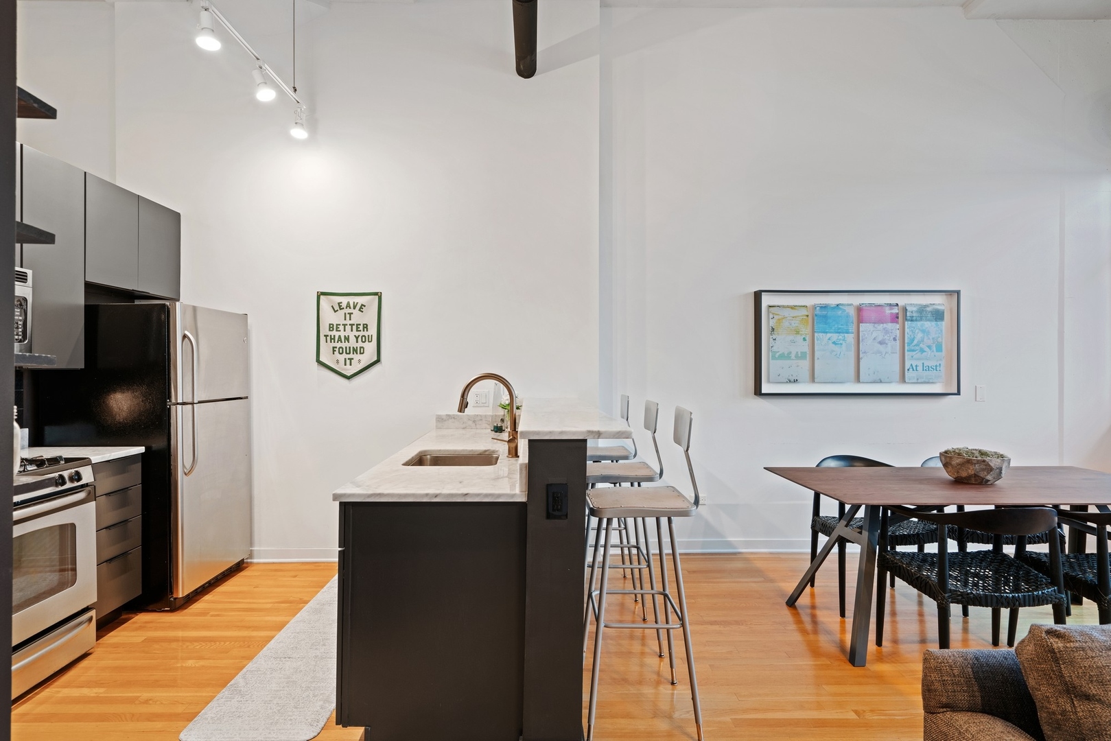 1224 West Van Buren Street, Unit 304 Chicago, IL 60607 - Photo 11 of 28 a dining room with furniture and a flat screen tv