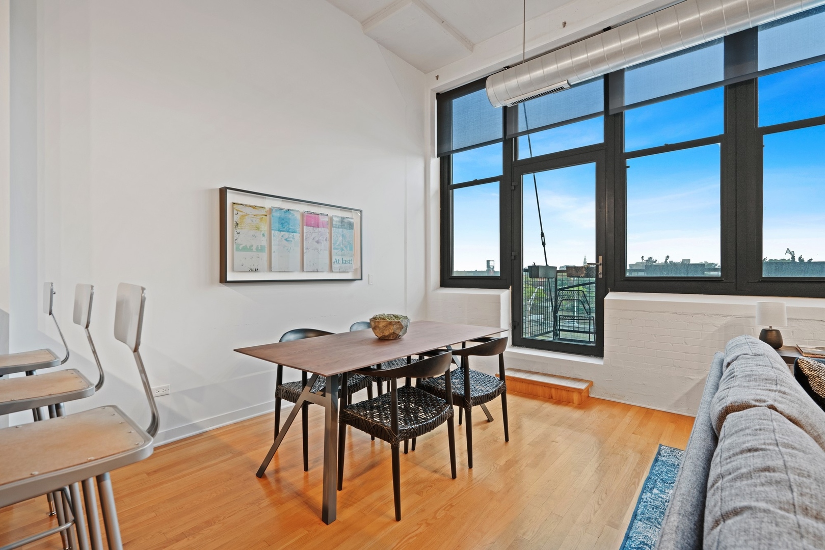 1224 West Van Buren Street, Unit 304 Chicago, IL 60607 - Photo 13 of 28 a view of a dining room with furniture and wooden floor