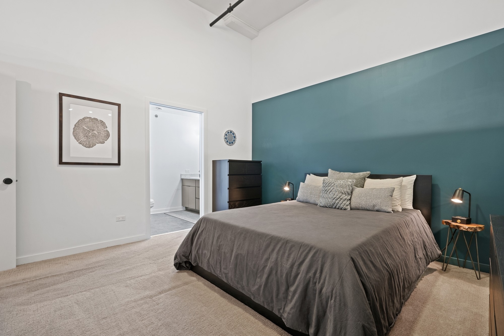 1224 West Van Buren Street, Unit 304 Chicago, IL 60607 - Photo 17 of 28 a bedroom with a bed and painting on the wall