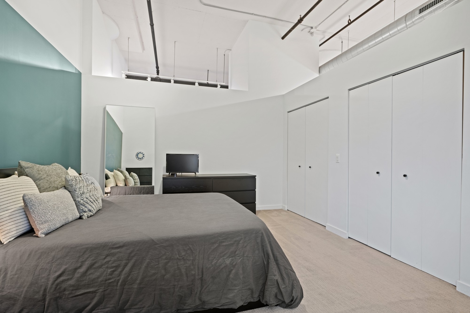 1224 West Van Buren Street, Unit 304 Chicago, IL 60607 - Photo 18 of 28 a bedroom with a bed and a ceiling fan