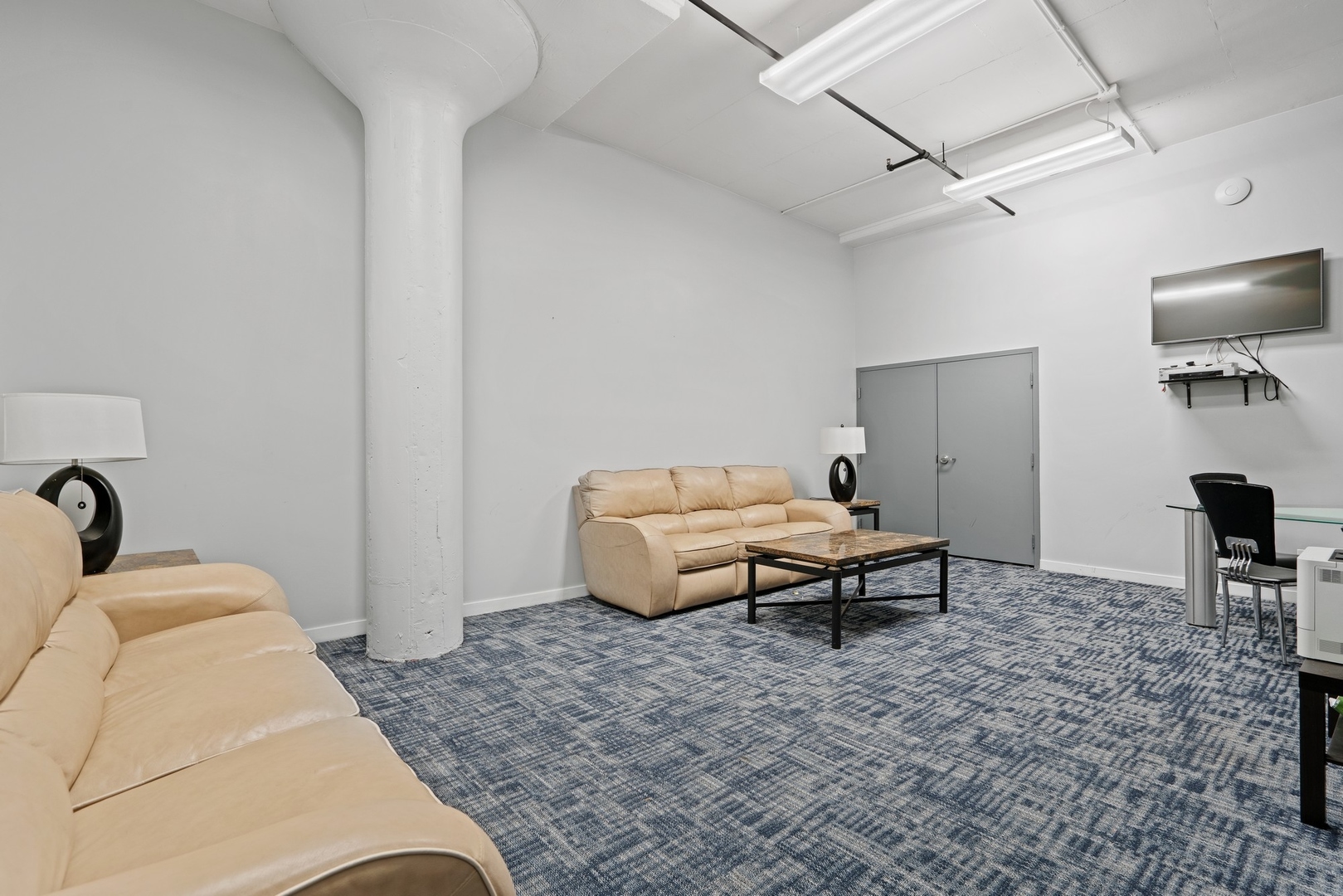 1224 West Van Buren Street, Unit 304 Chicago, IL 60607 - Photo 27 of 28 a living room with furniture and a flat screen tv