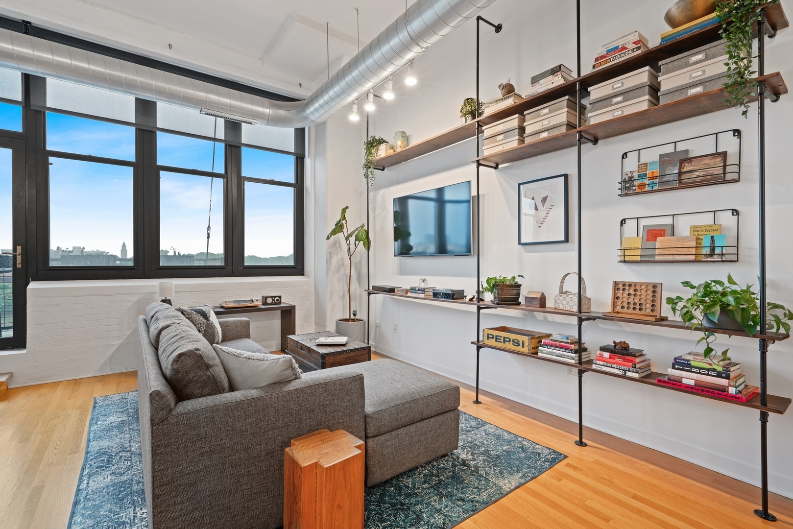 1224 West Van Buren Street, Unit 304 Chicago, IL 60607 - Photo 5 of 28 a living room with furniture and a flat screen tv