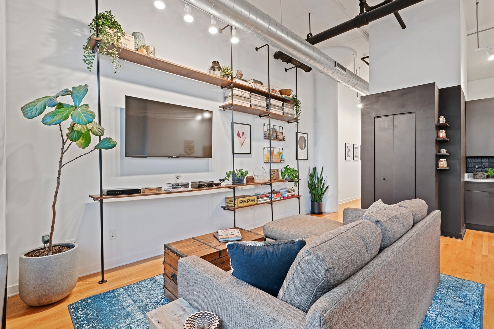 1224 West Van Buren Street, Unit 304 Chicago, IL 60607 - Photo 6 of 28 a living room with furniture and a flat screen tv