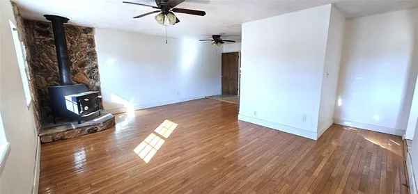 a view of livingroom with hardwood floor and a ceiling fan