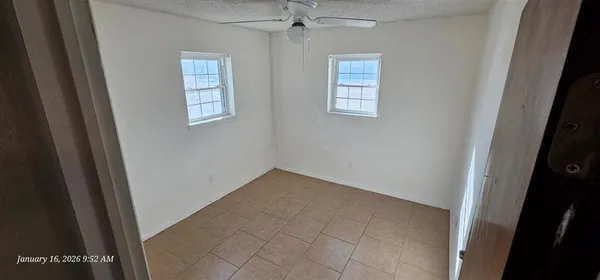 a view of an empty room with a window