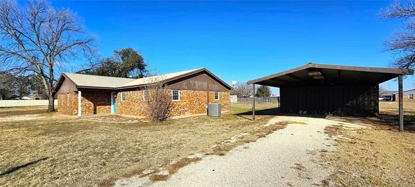 a view of a house with a yard covered in snow