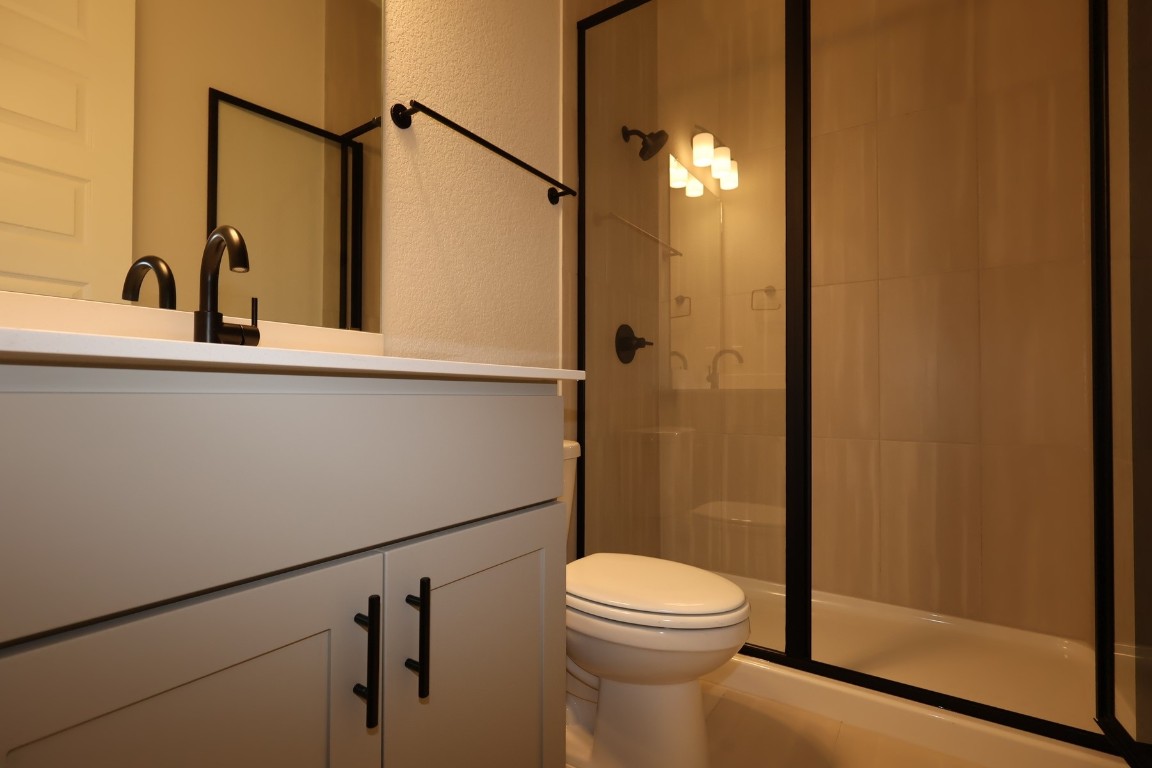 421 Leaning Rock Road Georgetown, TX 78628 - Photo 11 of 14 a bathroom with a toilet a sink and shower