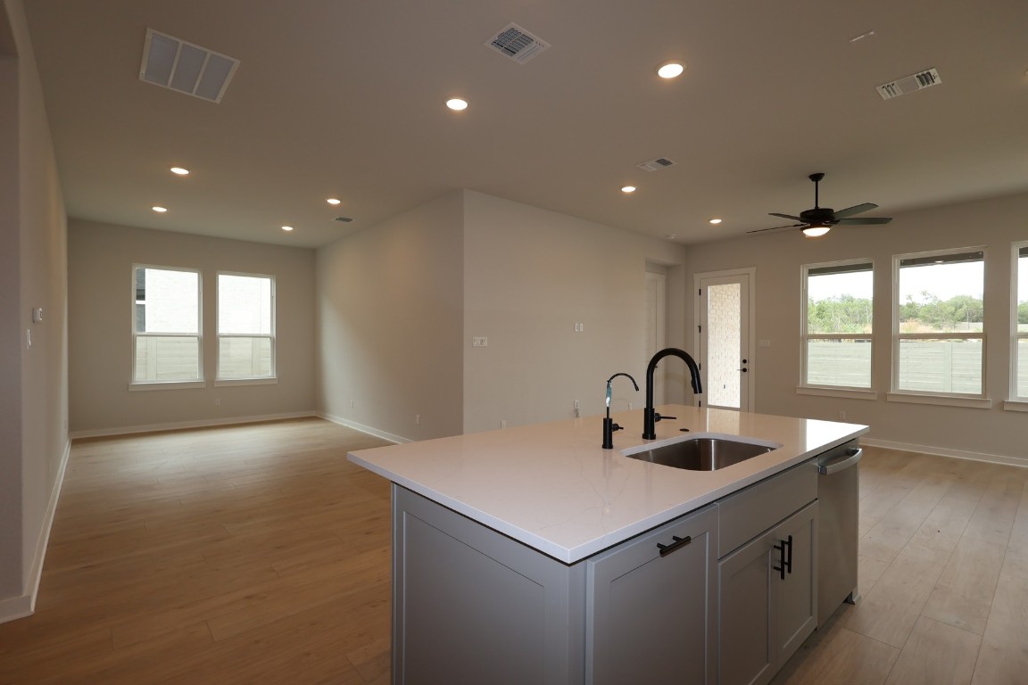 421 Leaning Rock Road Georgetown, TX 78628 - Photo 3 of 14 a kitchen with kitchen island a sink appliances and a large window