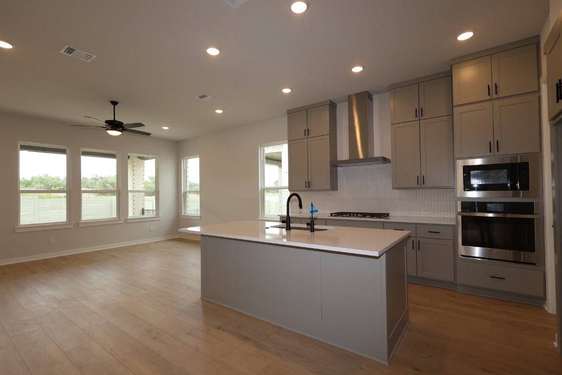 421 Leaning Rock Road Georgetown, TX 78628 - Photo 4 of 14 a kitchen with stainless steel appliances granite countertop a sink a stove and a refrigerator