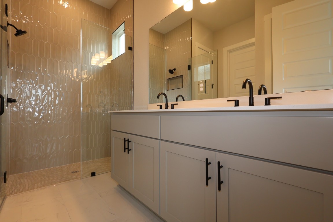 421 Leaning Rock Road Georgetown, TX 78628 - Photo 8 of 14 a bathroom with a sink and mirror