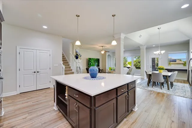 a kitchen with a stove center island wooden floor and a kitchen island