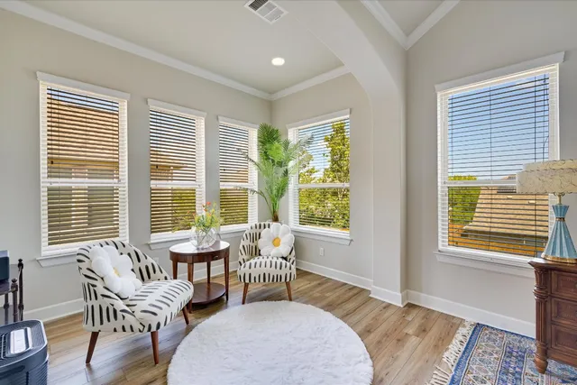 a living room with furniture and two windows