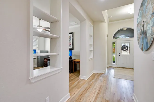 a view of a kitchen with fridge and wooden floor