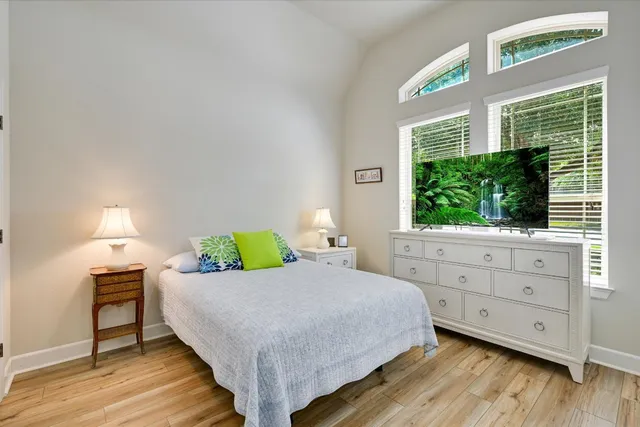 a bedroom with a bed window and a table