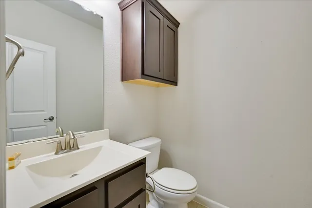 a bathroom with a sink a toilet and mirror