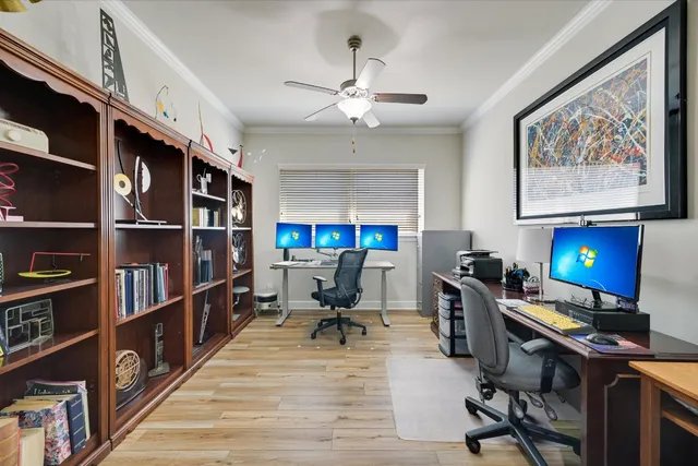 a view of a workspace with furniture and a bookshelf