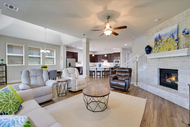 a living room with furniture a dining table and a fireplace