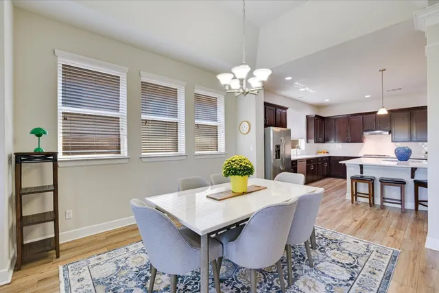 a view of a dining room with furniture and wooden floor