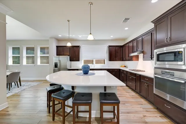 a large kitchen with a table and chairs