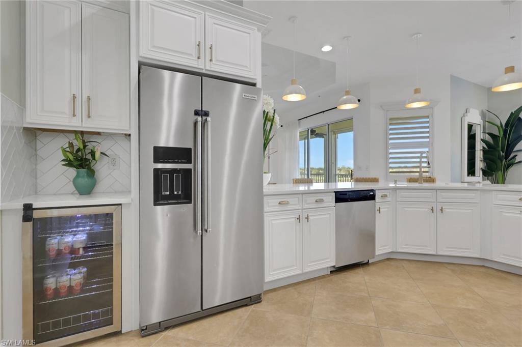 7877 Clemson Street, Unit 202 Naples, FL 34104 - Photo 11 of 36 a kitchen with white cabinets and refrigerator