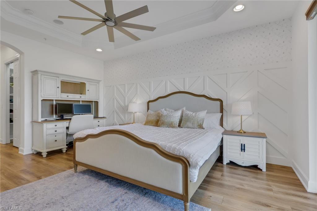 7877 Clemson Street, Unit 202 Naples, FL 34104 - Photo 18 of 36 a bedroom with a bed and a flat tv screen on dresser