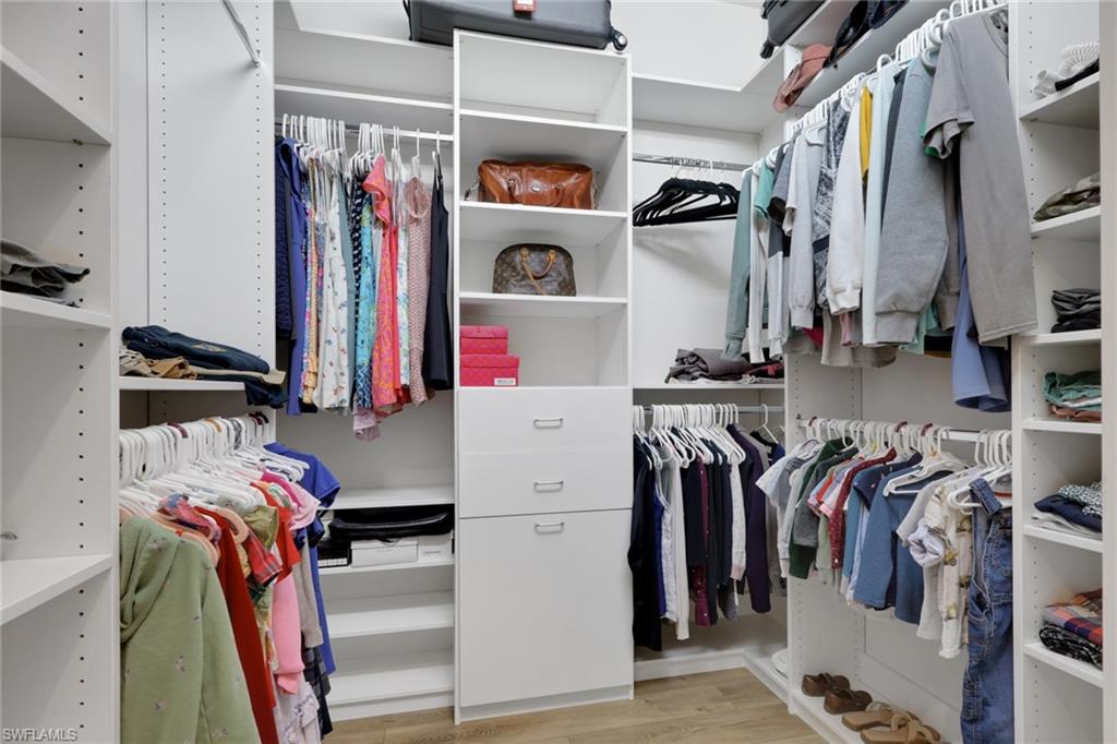 7877 Clemson Street, Unit 202 Naples, FL 34104 - Photo 21 of 36 a view of walk in closet with clothes and shoes
