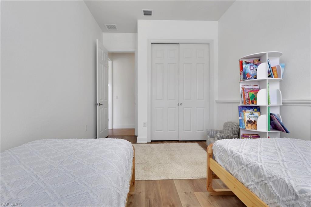 7877 Clemson Street, Unit 202 Naples, FL 34104 - Photo 27 of 36 a bedroom with a bed and hallway