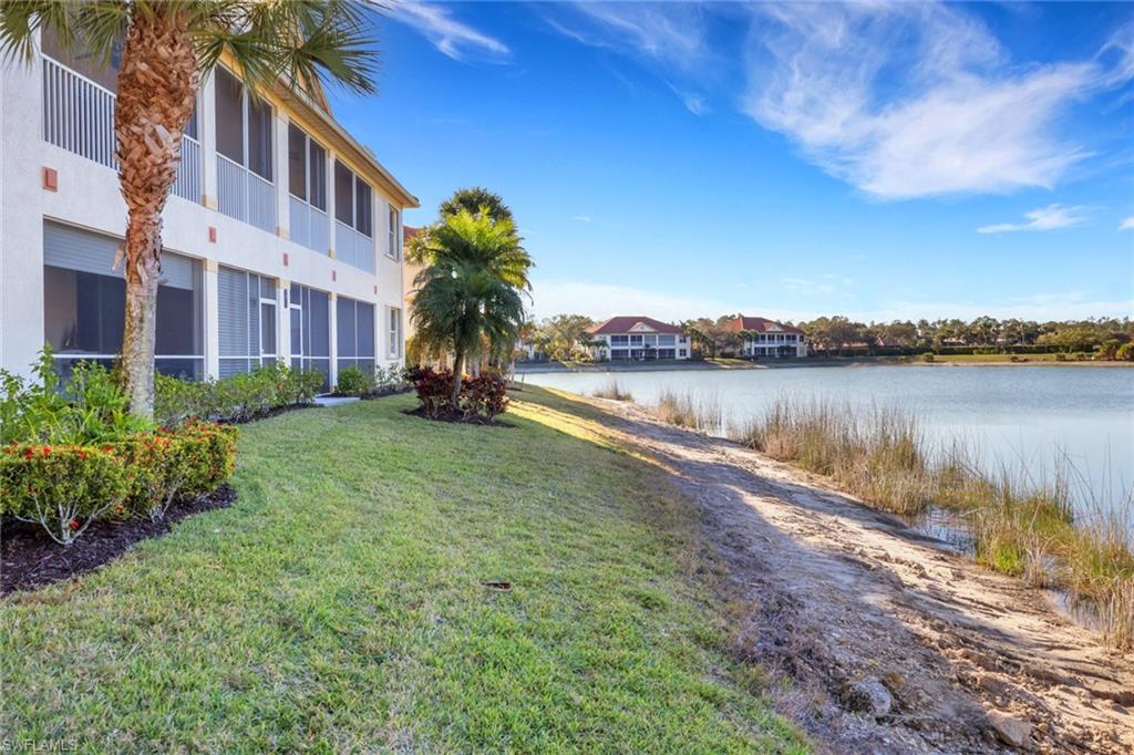 7877 Clemson Street, Unit 202 Naples, FL 34104 - Photo 34 of 36 a front view of a house with a yard and lake view