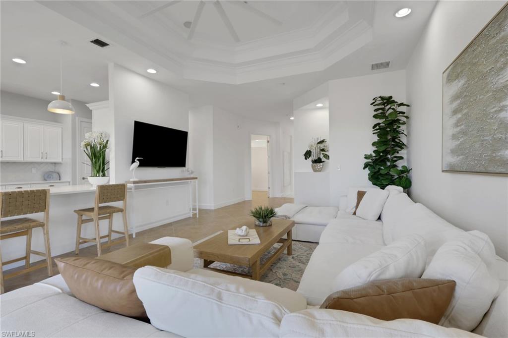 7877 Clemson Street, Unit 202 Naples, FL 34104 - Photo 4 of 36 a living room with furniture and a flat screen tv