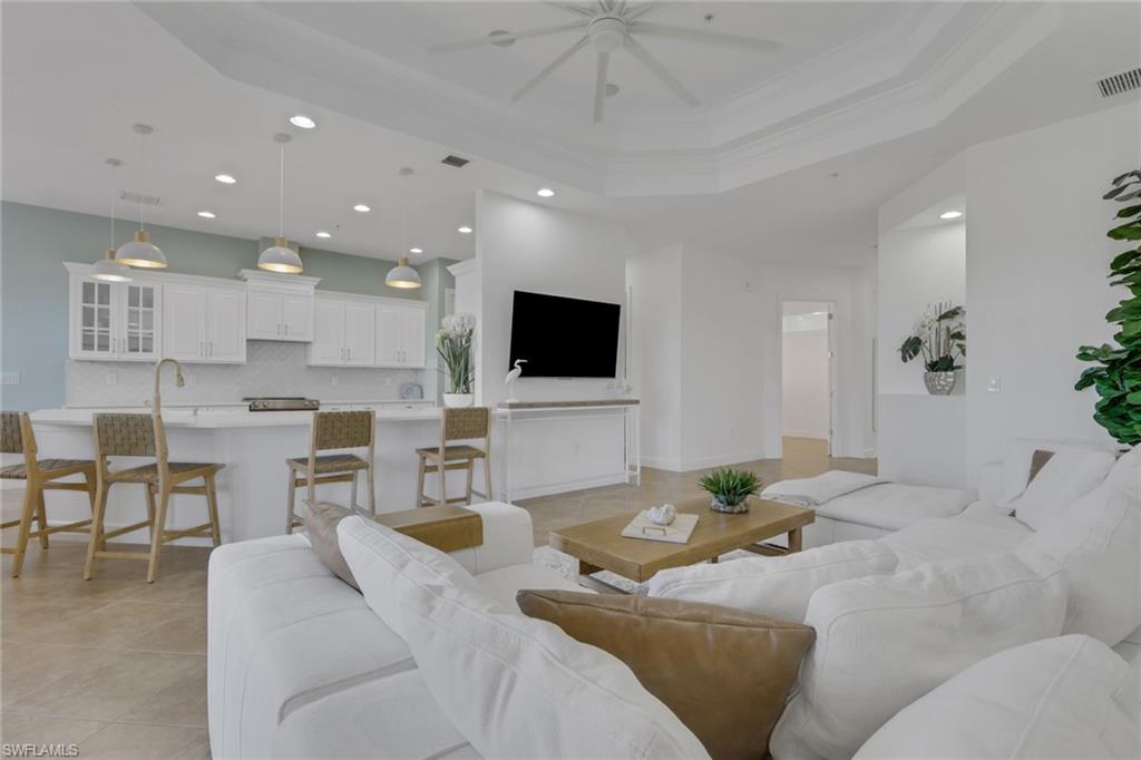 7877 Clemson Street, Unit 202 Naples, FL 34104 - Photo 5 of 36 a living room with furniture and a flat screen tv