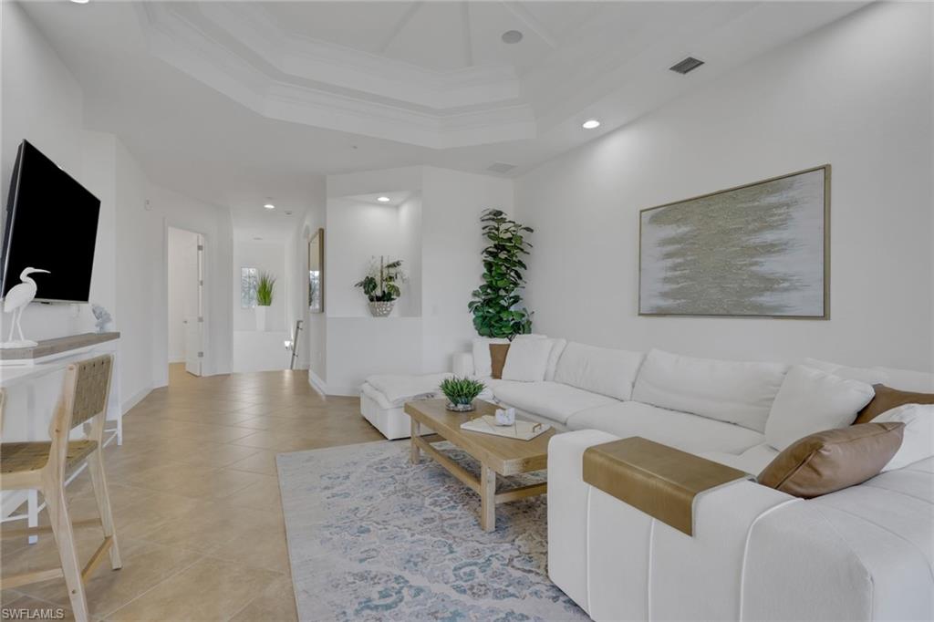 7877 Clemson Street, Unit 202 Naples, FL 34104 - Photo 6 of 36 a living room with furniture and a flat screen tv